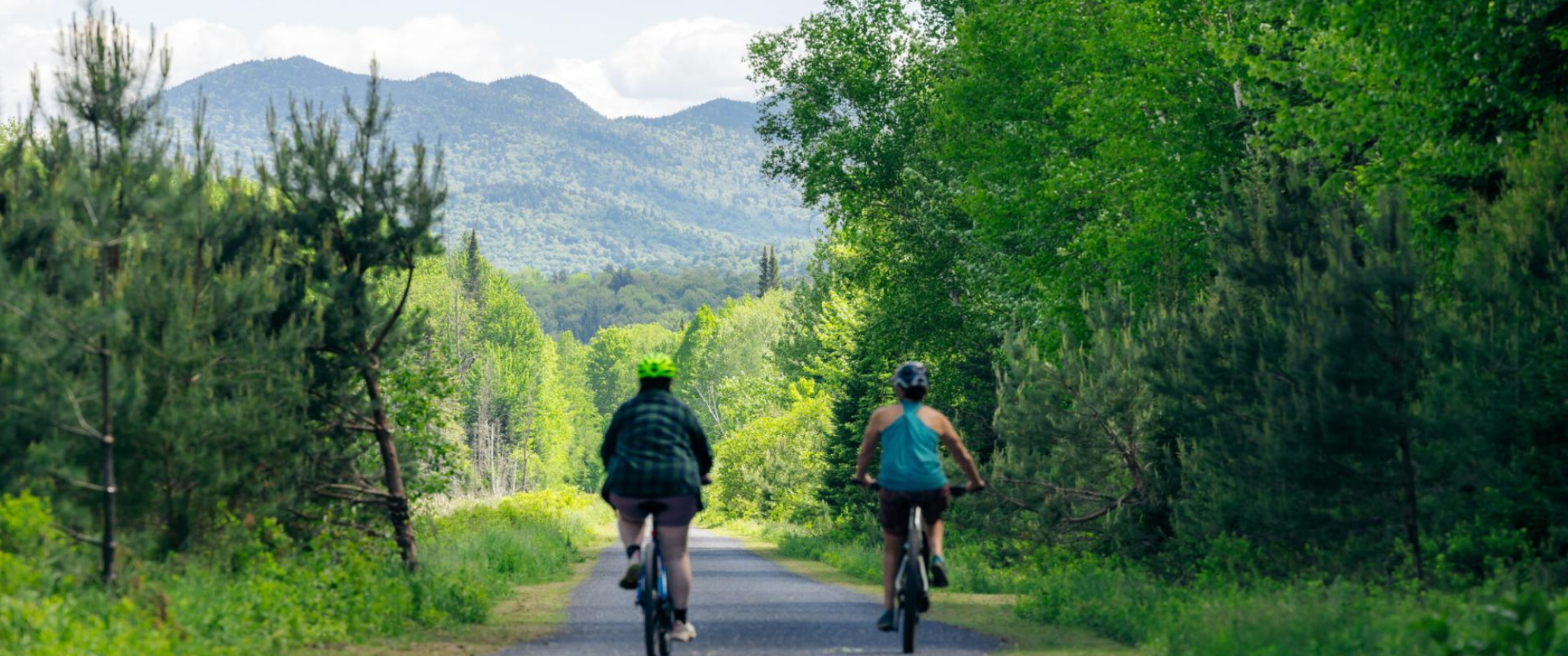 A man riding a bike down a dirt road