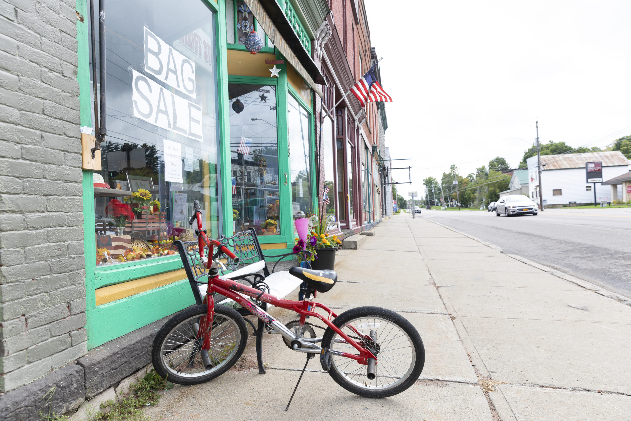 A bicycle sits outside a storefront in Chateaugay