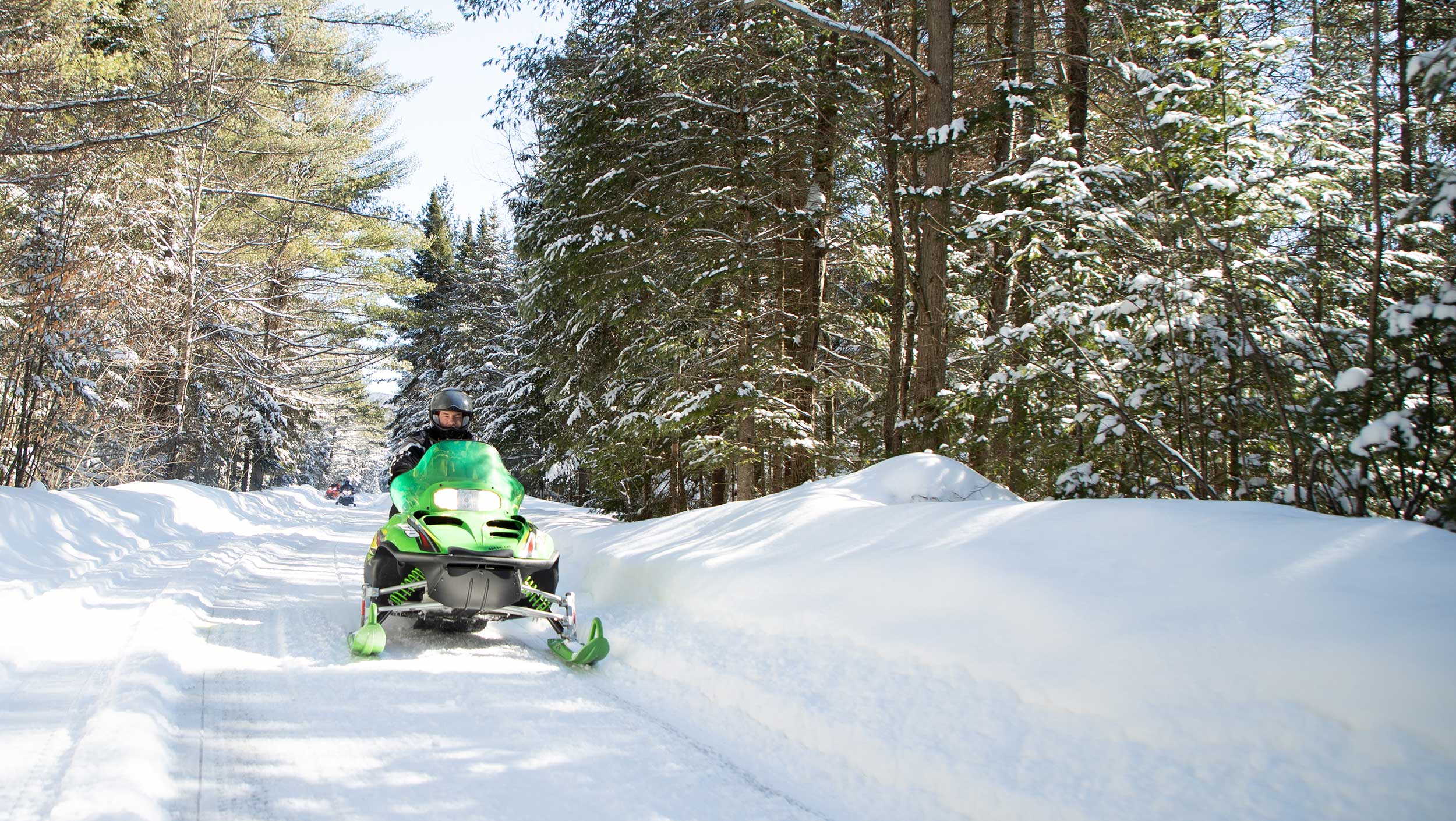 A man riding a snowboard down a snow covered slope